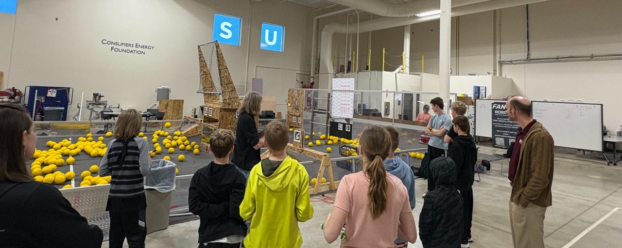 Middle school students look on as Calvin Christian High School use the FIRST Robotics Practice Field